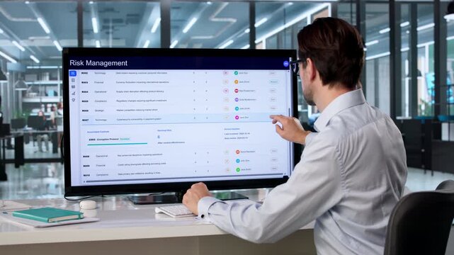 Risk Manager Analyzes Financial Data On Touchscreen