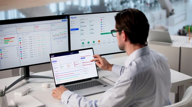 Business Manager Reviews OKR Dashboard On Laptop Tracking Team Performance