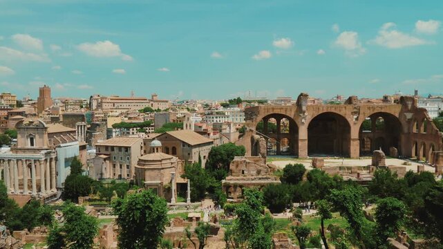 Roman forum ruins aerial panoramic view of ancient rome architecture with temple of antoninus and faustina basilica of maxentius historical italian heritage site on sunny day cinematic motion footage.
