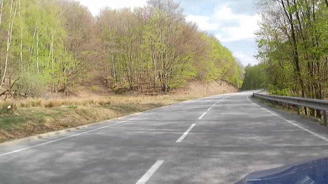 Uphill spring road drive video in Little Carpathian mountains, on road curves of Pezinska Baba mountain pass, western Slovakia.