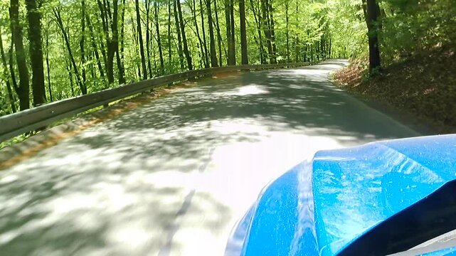 Sunny spring curvy downhill ride on shaky narrow local road in Stiavnica mountains, central Slovakia, between town of Banska Stiavnica and Hodrusa - Hamre.