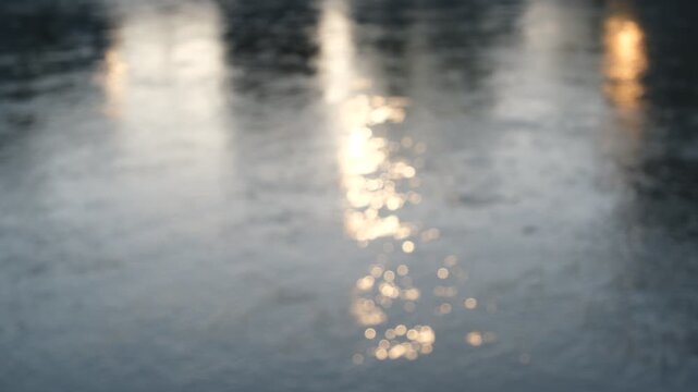 Defocused light reflections on fast flowing river water, silent abstract background footage