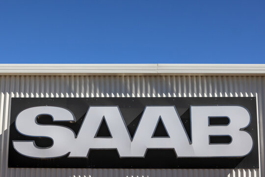 Perth, Western Australia - May 3 2026: Saab Automobile car manufacturer or producer logo and brand name against building exterior. Copy space in blue sky