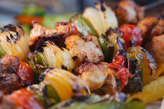Grilled meat and vegetables on a skewer at a summer cookout