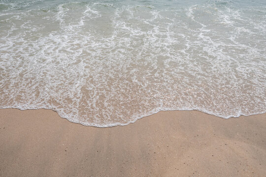 Sea blue wave with sand beach at coast vacation holidays tropical.