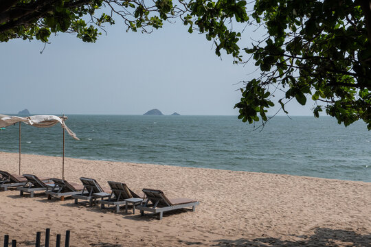 Tropical beach view with sun bed and umbrellas.