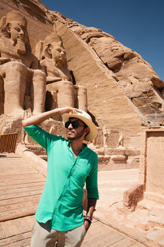 Happy traveler admiring ancient Egyptian architecture at the Great Temple of Ramesses II