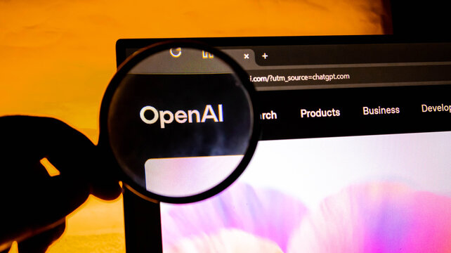 Magnifying glass held over the openai logo on a computer screen