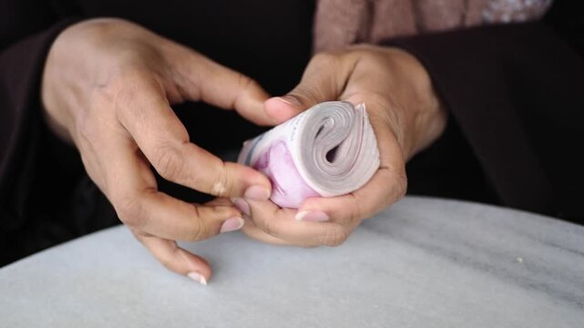 Counting turkish lira in a busy cafe during afternoon hours