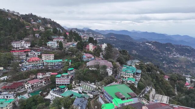 Scenic aerial and street level views of Mussoorie, Uttarakhand, featuring misty hills, colonial charm, mountain roads, pine forests, cafes, and vibrant tourist life in the Queen of Hills.