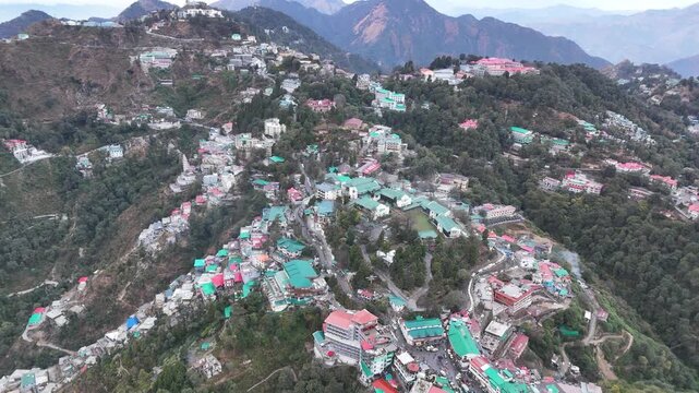 Scenic aerial and street level views of Mussoorie, Uttarakhand, featuring misty hills, colonial charm, mountain roads, pine forests, cafes, and vibrant tourist life in the Queen of Hills.