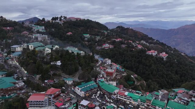 Scenic aerial and street level views of Mussoorie, Uttarakhand, featuring misty hills, colonial charm, mountain roads, pine forests, cafes, and vibrant tourist life in the Queen of Hills.
