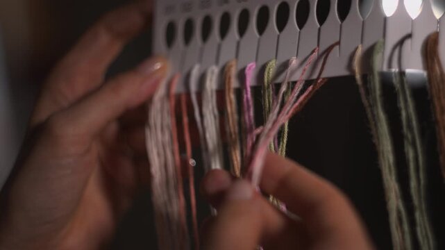 Colorful Cords Organized Meticulously. Craftsman Skillfully Arranges Pastel Floss Into Structured Rows. Media