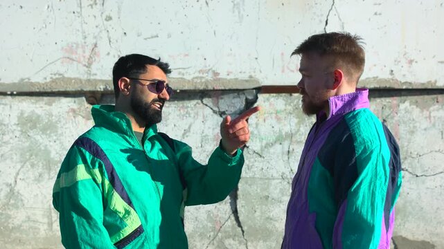 Peaceful Resolution In Urban Setting. Diverse Men Mediate Near Weathered Concrete In Bright Sunlight. Media