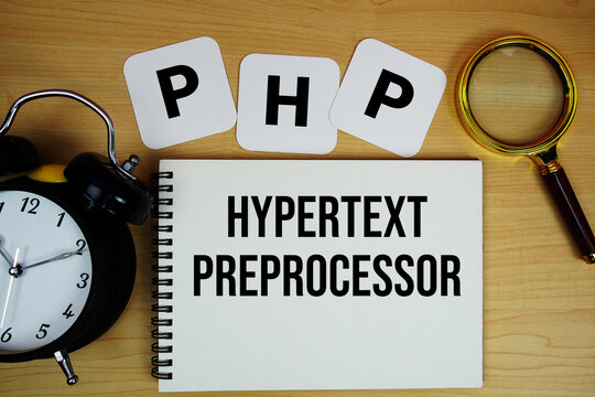 PHP Hypertext Preprocessor text written on notepad with magnifying glass and alarm clock on wooden background