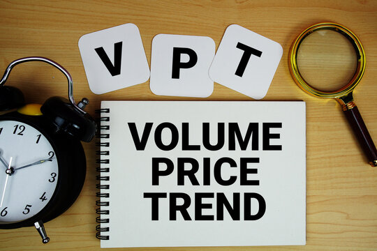 VPT Volume Price Trend Indicator text written on notepad with magnifying glass and alarm clock on wooden background