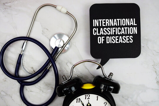 International Classification of Diseases (ICD) text with stethoscope and alarm clock on marble background