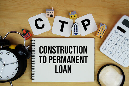 C to P Construction to Permanent Loan text written on notepad with house model, alarm clock and magnifying glass on wooden background