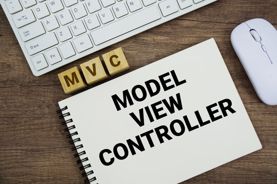 MVC Model&ndash;View&ndash;Controller message with keyboard and optical mouse on wooden background