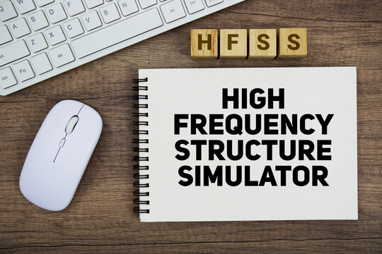 HFSS High Frequency Structure Simulator message with keyboard and optical mouse on wooden background