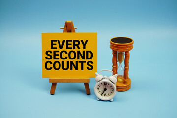 Fototapeta premium Every Second Counts text with alarm clock and hourglass on blue background