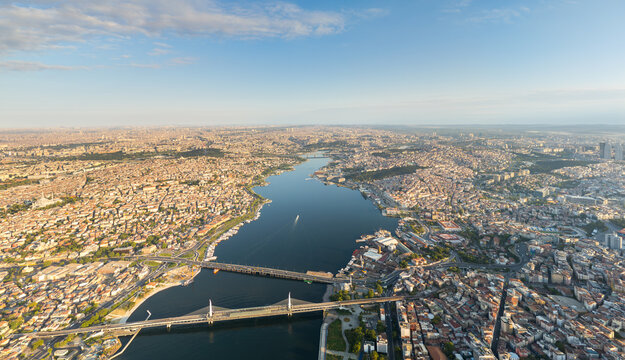 Istanbul, Turkey. European shores of Golden Horn, aerial panorama with Halic Metro Bridge and Ataturk Bridge connecting historic districts. Aerial view
