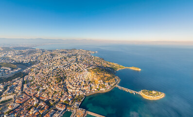 Kusadasi, Turkey. Aerial panorama of coastline with Pigeon Island Fortress and Mount Kese in morning haze. Atmospheric coastal landscape with historical landmark. Aerial view. © Video Render