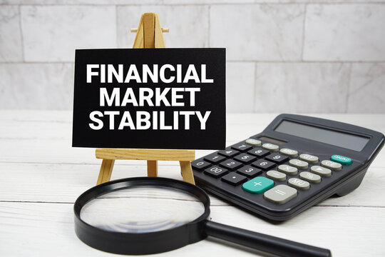 Financial Market Stability text with calculator and magnifying glass