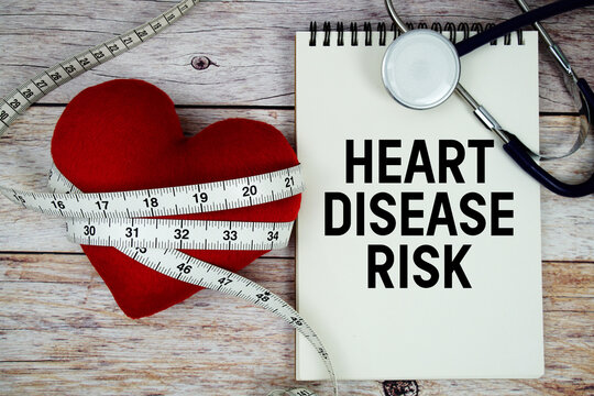 Heart Disease Risk text with stethoscope and wrap a measuring tape around red heart on wooden background