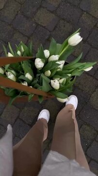 Female Hand Holding Bag Filled with Fresh White Tulips in Elegant Aesthetic Style