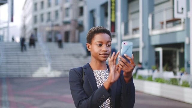 Business, phone and black woman in city for app, online and search for location or communication. Professional, employee or person with scroll or typing for travel news, outdoor and career update