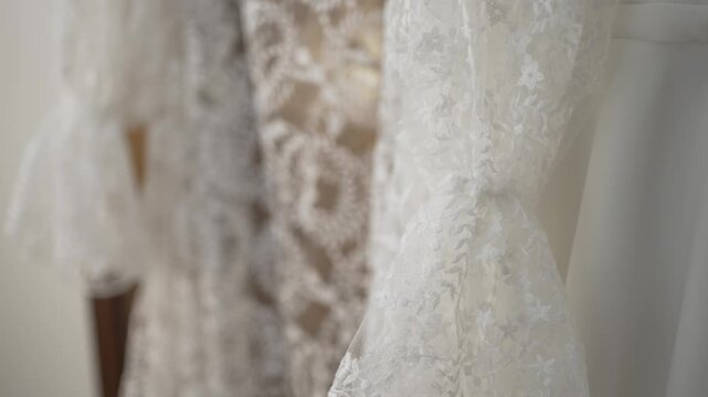 Close up of white wedding dress lace with delicate floral embroidery and soft texture detail