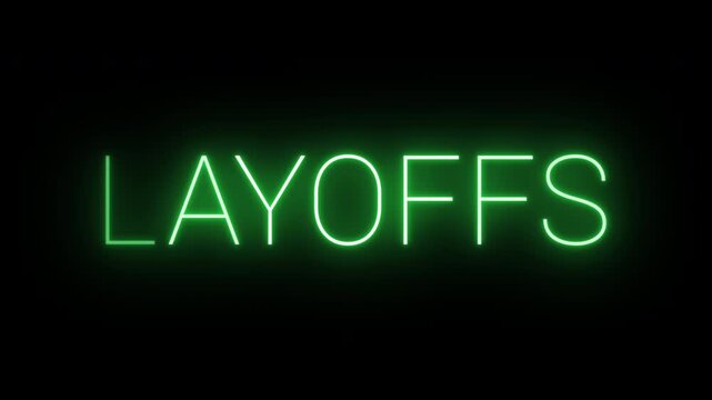 Flickering neon green glowing layoffs sign animated black background.