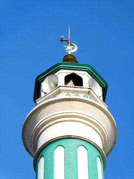 Serene Green And White Mosque Minaret With Crescent Moon Finial Under Clear Blue Sky On Sunny Day Islamic Architecture
