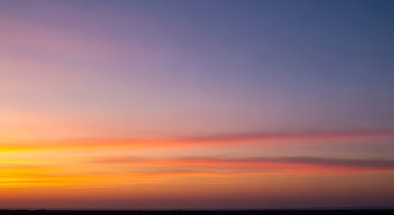 Obraz premium Beautiful colorful sunrise sky with vibrant orange and purple hues.