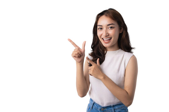 Smiling Asian woman pointing at copy space on transparent background