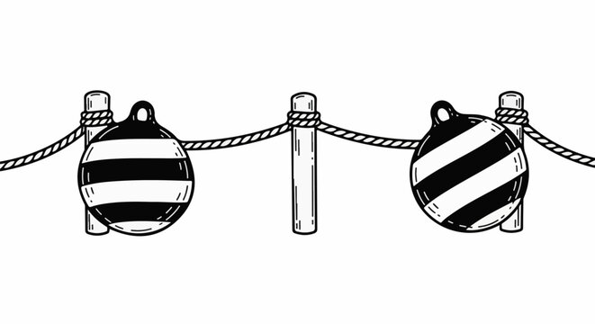 Two nautical buoys on a rope barrier between wooden posts