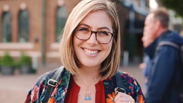 Outdoor, face or woman with smile for education, international student or pride for study opportunity. Confident, wind or scholar with portrait for abroad travel, exchange programme or learn culture