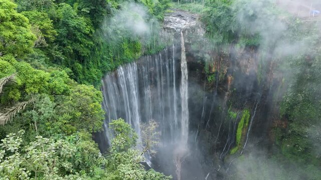 Java Island Indonesia Dramatic Drone Shot of Tumpak Sewu Waterfall in Tropical Jungle