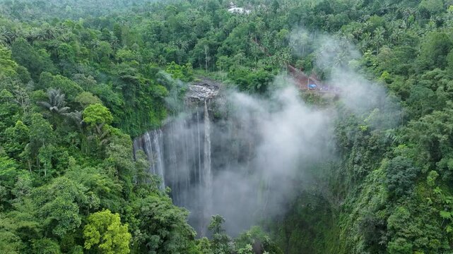 Tumpak Sewu Waterfall Aerial Cinematic Shot with Mist Clouds &ndash; Java Island Indonesia