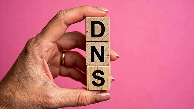 Hand holding DNS wooden blocks representing futuristic concepts and abstract thought