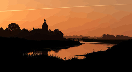 Fototapeta premium Silhouette of a historic church by a river during golden sunset