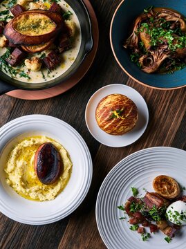 Assortment of Gourmet Fine Dining Dishes Including Pork Belly and Roas