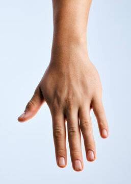 Man, hand and skincare in studio with nail care, beauty salon or natural cosmetics for dermatology. Person, healthy cuticles or manicure with clear polish, wellness or smooth skin on white background
