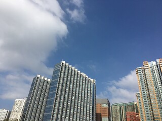 Hong Kong residential skyscrapers under blue sky with modern urban cityscape © TORIZUKA