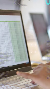 Vertical video: Analyst hands tapping touchpad, typing on laptop, activating HUD charts for finance