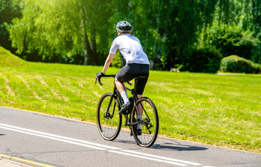 Fototapeta premium Cyclist ride on the bike path in the city Park 