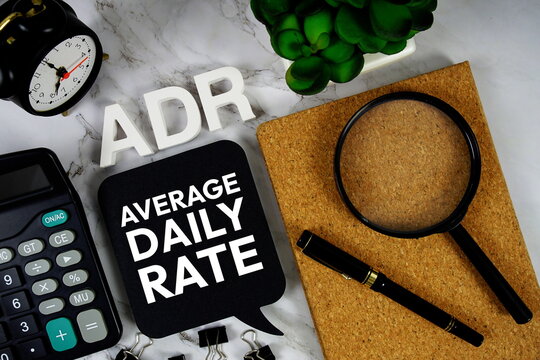 ADR Average Daily Rate acronym with calculator, alarm clock and magnifying glass, Business concept background