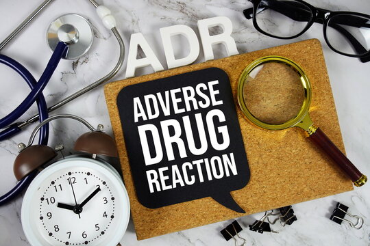 ADR Adverse Drug Reaction acronym with alarm clock and magnifying glass, medical and healthcare concept background