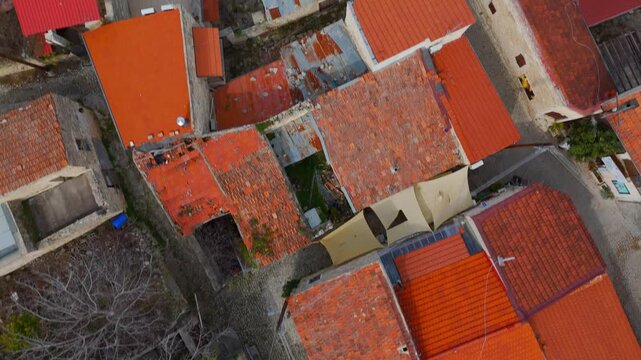Aerial Top Down View of Traditional Tiled Rooftops and Cobbled Streets in Lofou Village Cyprus
